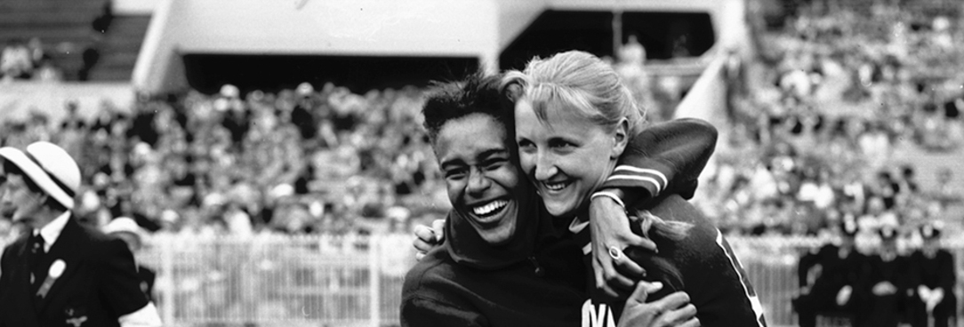 Black and white image of two Olympians hugging from 1956 olympics