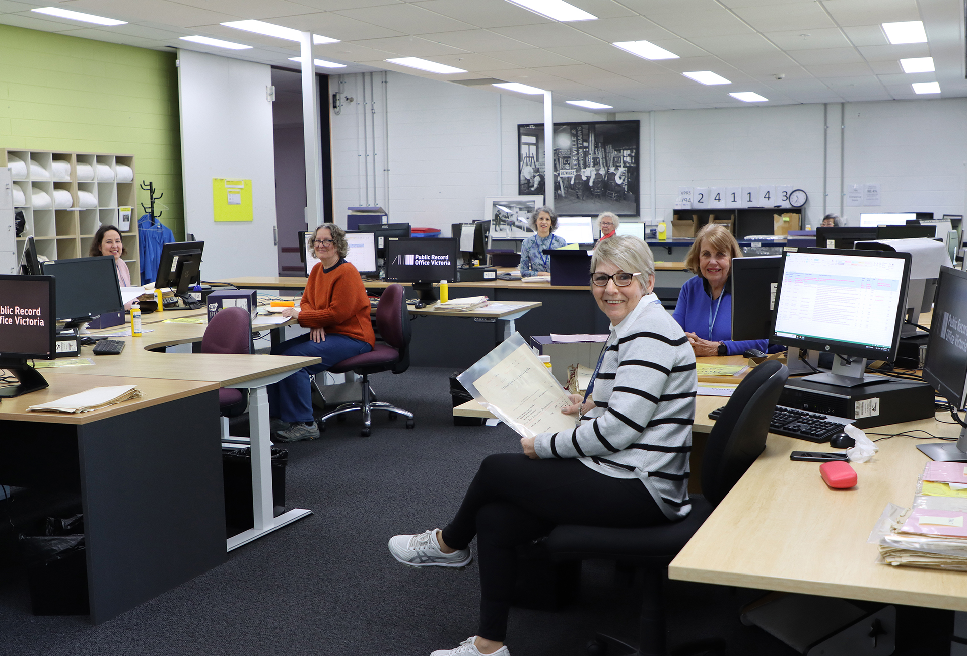 a group of volunteers working at their computers