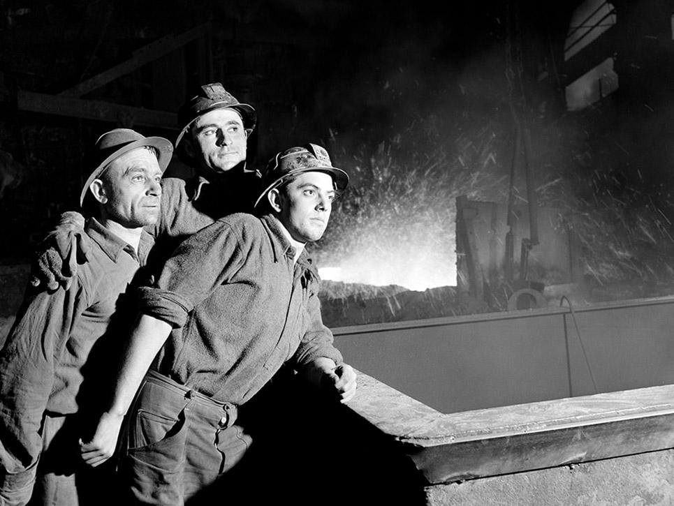 firefighters overlooking a smoky building ledge