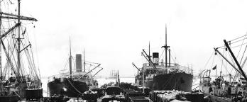Black and white photo of ships at dock