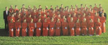 photo of the choir lined up in their red uniforms