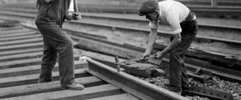 Black and white photo of men working on railway tracks