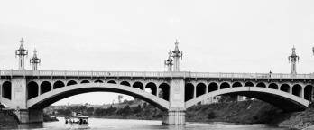 Black and white photo of bridge over a river