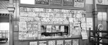 Spencer Street main concourse newspaper kiosk with painted signs for The Age, The Sun, The Weekly Times and The Herald. 18TH July 1936. VPRS 12800/ P3  item ADV 1151
