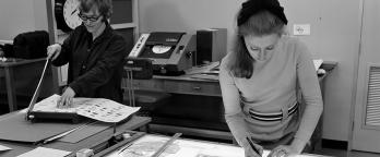 black and white photograph of two women working on a design project in a studio in the 1960s
