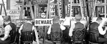 black and white photo of men painting signs