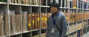 photo of a student standing in the archives repository