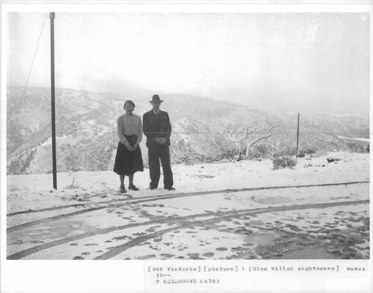 two people standing in the snow